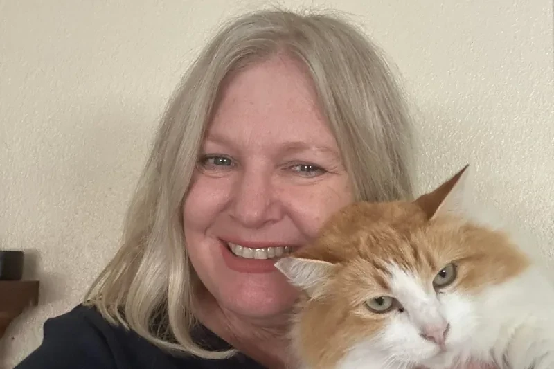 Rescue founder Pamela Vandervoort holding an orange-and-white cat.